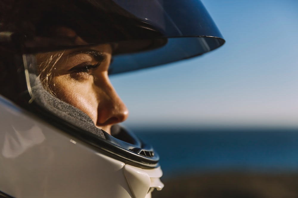 En kvinna med en MC hjälm